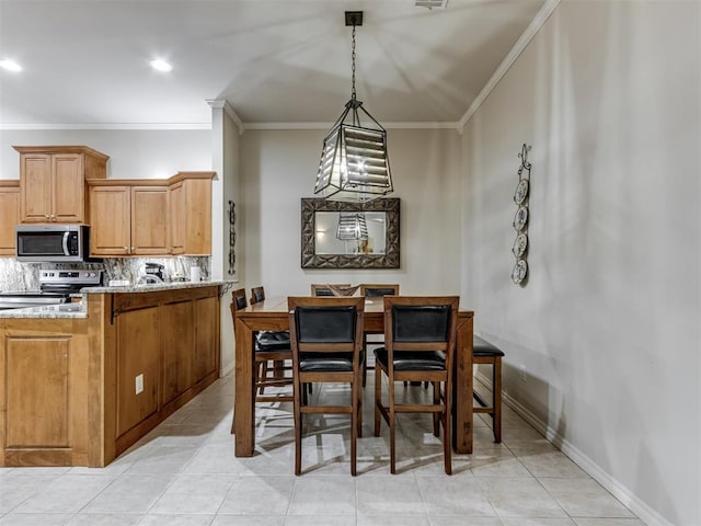 dining room with ornamental molding and light tile patterned flooring