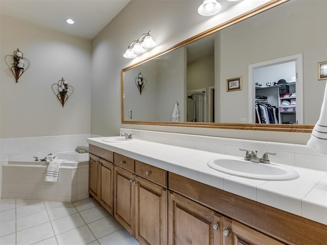 bathroom with vanity, independent shower and bath, and tile patterned flooring