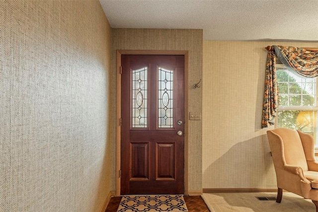 entrance foyer featuring a textured ceiling