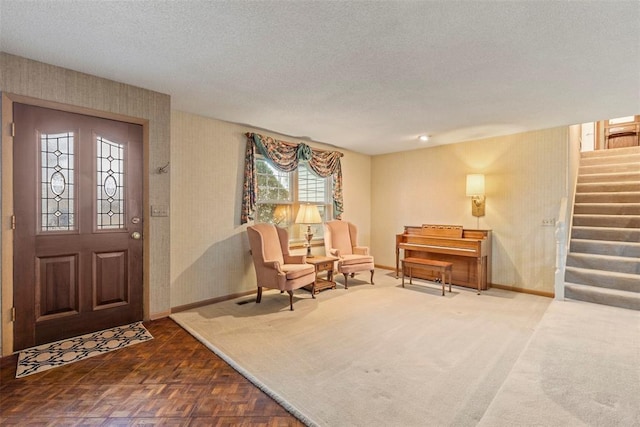 foyer featuring parquet floors and a textured ceiling