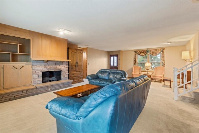 carpeted living room featuring a stone fireplace