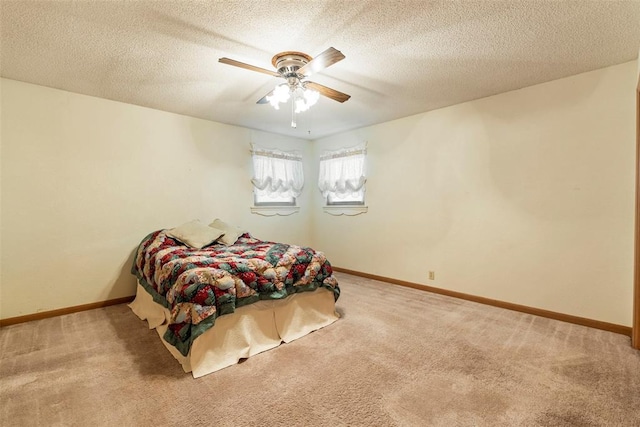 carpeted bedroom with a textured ceiling and ceiling fan