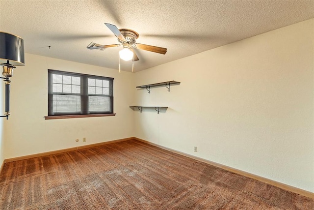 carpeted empty room with ceiling fan and a textured ceiling