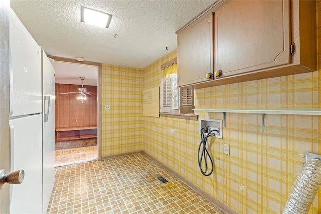 laundry room with cabinets, ceiling fan, washer hookup, and a textured ceiling