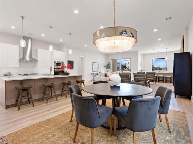 dining room featuring recessed lighting, visible vents, and light wood-style flooring