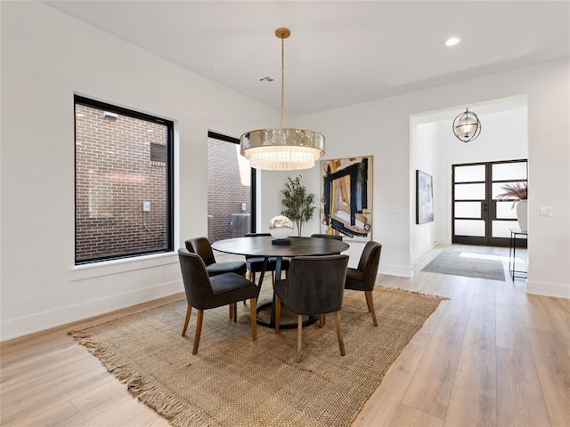 dining room featuring recessed lighting, light wood-style flooring, baseboards, and french doors