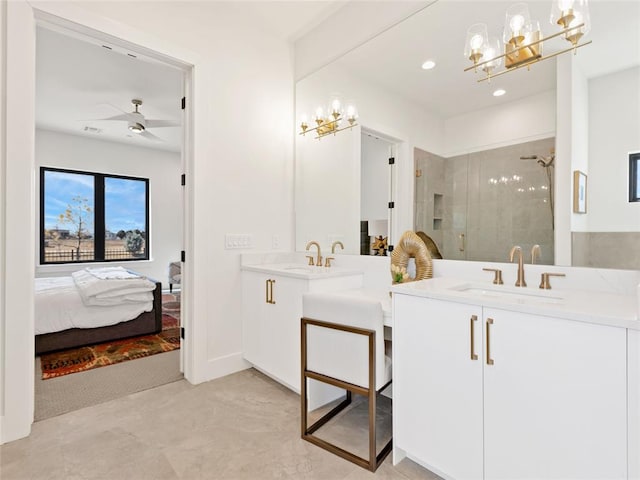 ensuite bathroom with a stall shower, two vanities, a sink, and ensuite bathroom