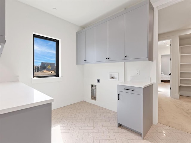 washroom featuring cabinet space, washer hookup, and electric dryer hookup