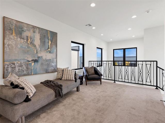 living area featuring recessed lighting, visible vents, and carpet flooring