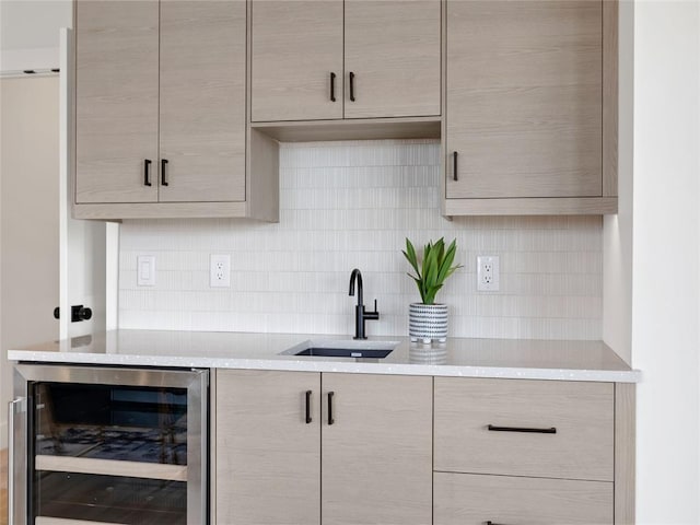 kitchen featuring light countertops, wine cooler, modern cabinets, and a sink