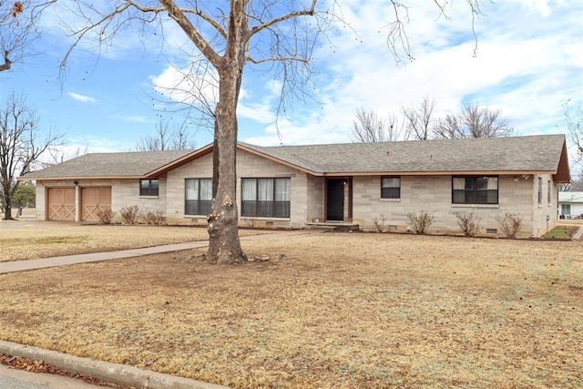 single story home with a garage and a front lawn