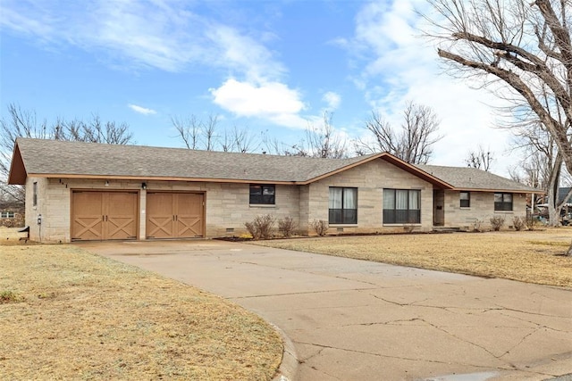 ranch-style home featuring a garage and a front lawn