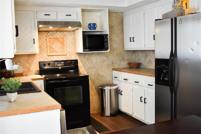 kitchen with white cabinetry, backsplash, range hood, black appliances, and dark hardwood / wood-style flooring