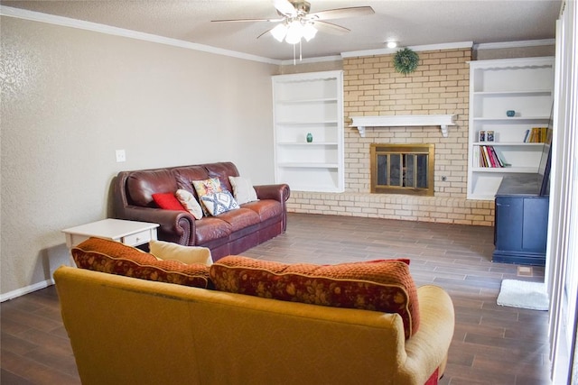 living room featuring a textured ceiling, ornamental molding, built in features, ceiling fan, and a fireplace