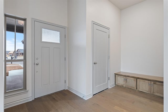 entryway featuring baseboards and light wood-style floors