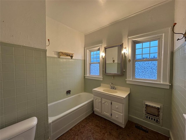 bathroom with vanity, toilet, and tile walls