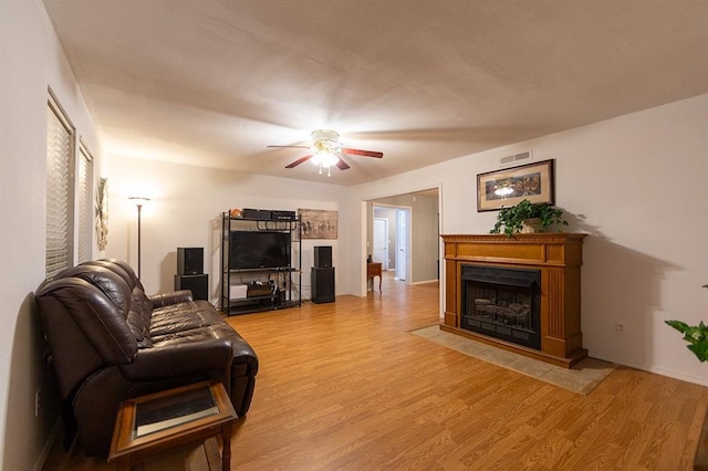 living room featuring ceiling fan and wood-type flooring