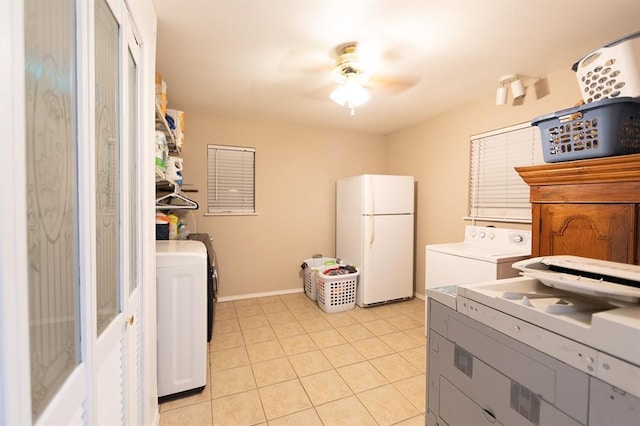 clothes washing area featuring ceiling fan, washing machine and clothes dryer, and light tile patterned flooring