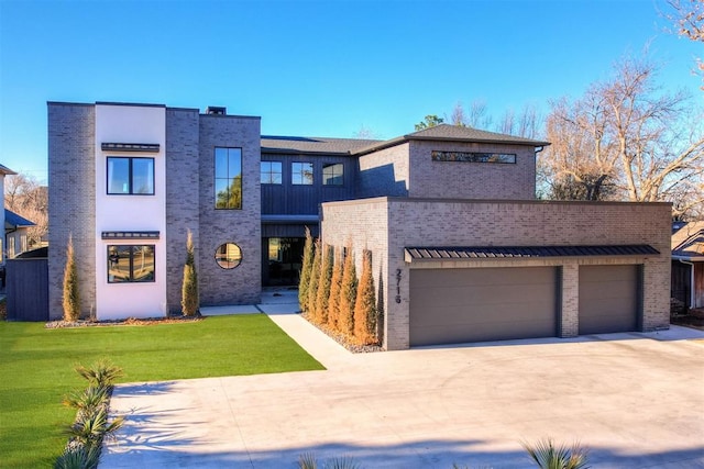 view of front of property with a garage and a front lawn