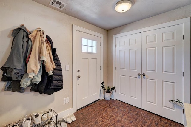 foyer entrance with dark wood-style floors and visible vents