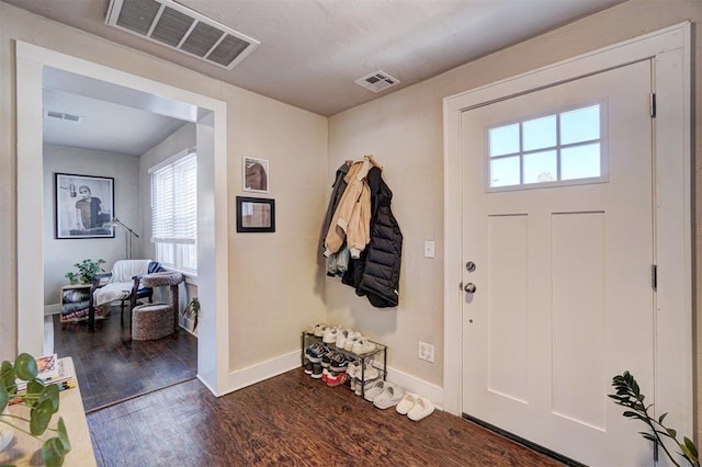 foyer featuring wood finished floors, visible vents, and baseboards