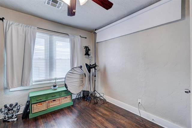 playroom featuring baseboards, visible vents, dark wood finished floors, a textured ceiling, and a textured wall