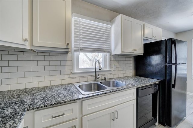 kitchen featuring dishwasher, decorative backsplash, dark stone countertops, white cabinets, and a sink