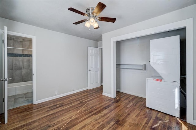 unfurnished bedroom featuring a ceiling fan, wood finished floors, baseboards, a closet, and connected bathroom