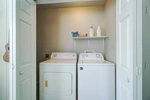 washroom featuring laundry area and separate washer and dryer