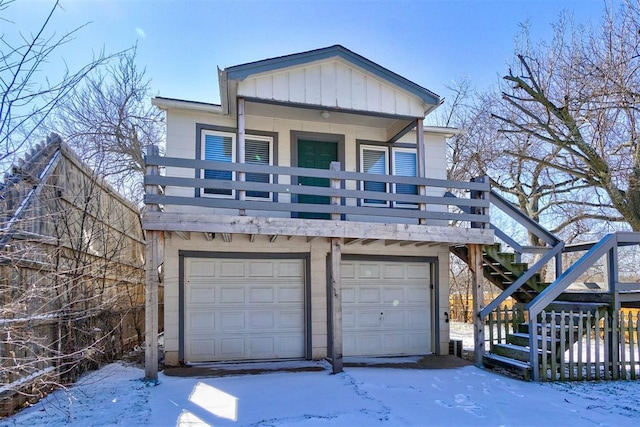 view of front of home with stairway, board and batten siding, and an attached garage