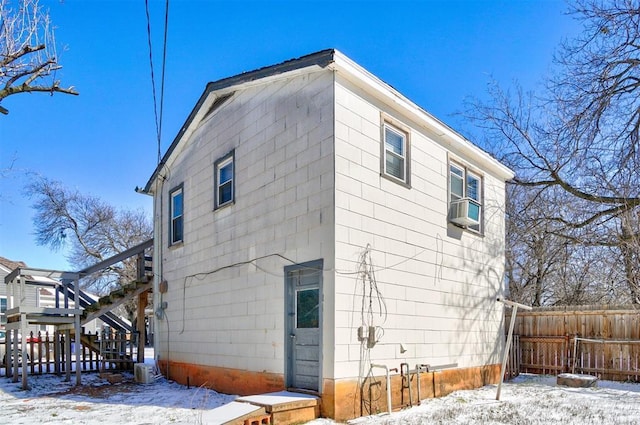 exterior space featuring cooling unit, stairs, and fence