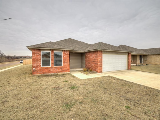 ranch-style home featuring a garage and a front lawn