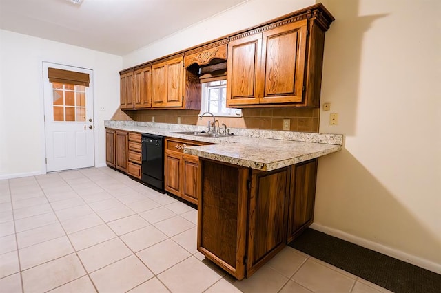 kitchen featuring dishwasher, sink, and light tile patterned floors