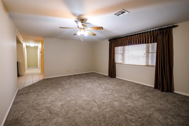 spare room featuring light carpet and ceiling fan