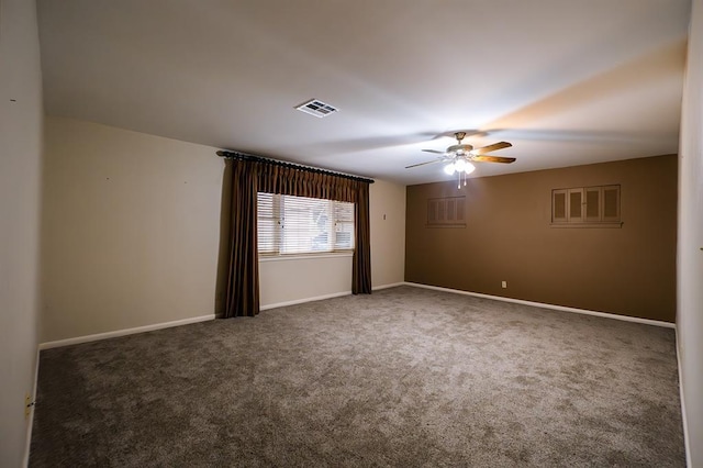 spare room featuring ceiling fan and dark colored carpet