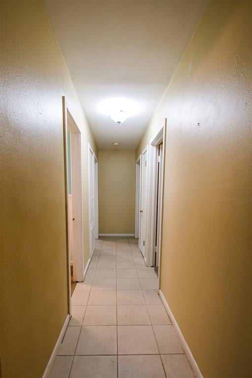 hallway featuring light tile patterned floors