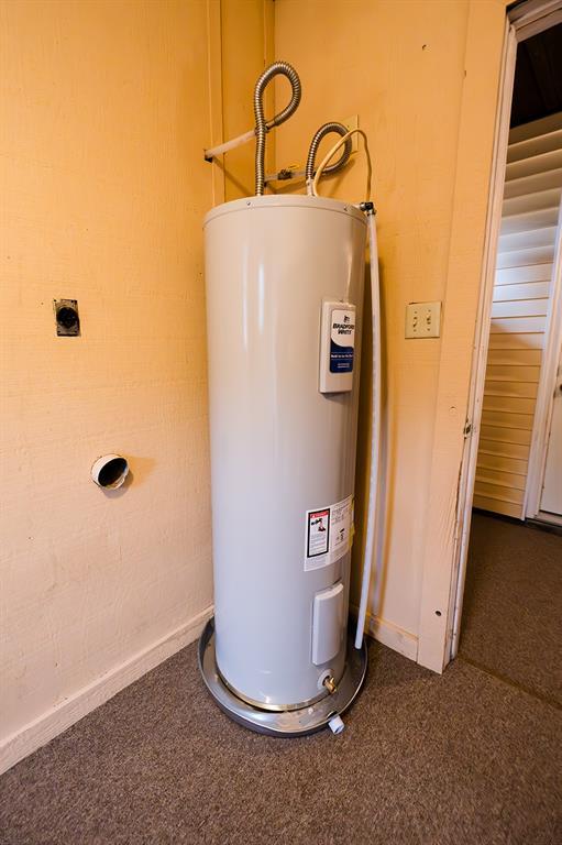 utility room with electric water heater