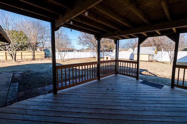 wooden deck featuring a storage unit