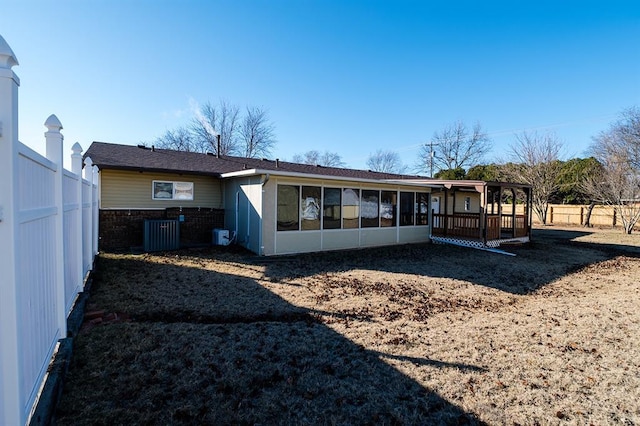 back of house with a sunroom and central AC unit