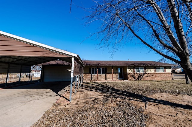 view of front of home with brick siding and a detached garage