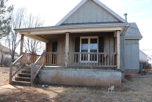 308 S Main St, Custer City, OK 73639 - rear view of property featuring board and batten siding, covered porch, and roof with shingles