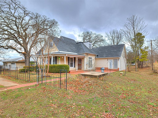 rear view of house with a yard and covered porch