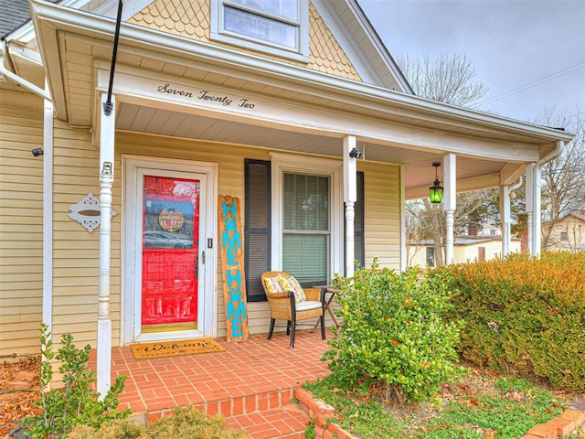 view of exterior entry featuring covered porch