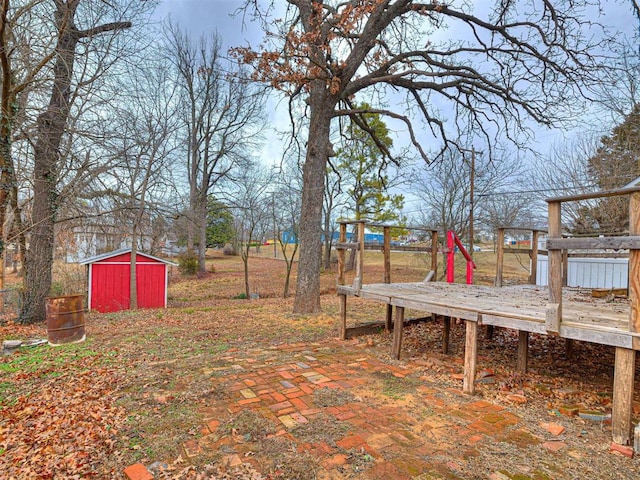 view of yard with a storage unit and a deck