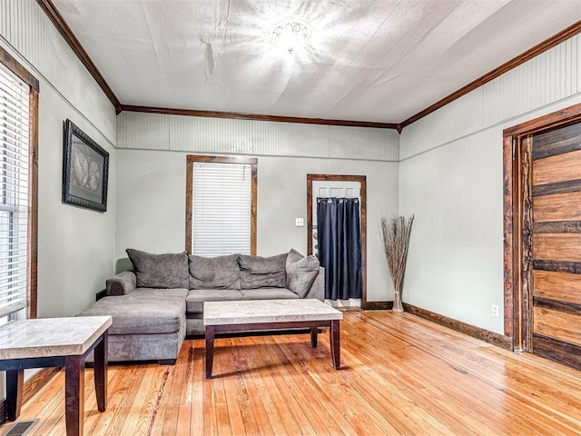 living room featuring ornamental molding and hardwood / wood-style floors