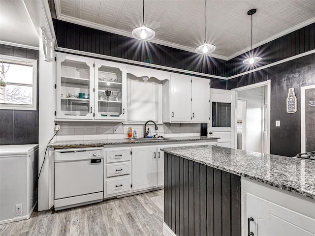 kitchen featuring sink, white cabinetry, ornamental molding, white dishwasher, and pendant lighting