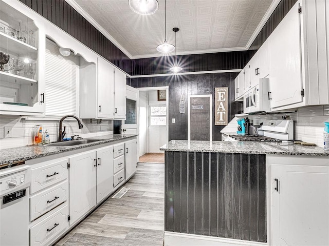 kitchen featuring sink, white cabinetry, ornamental molding, pendant lighting, and white appliances