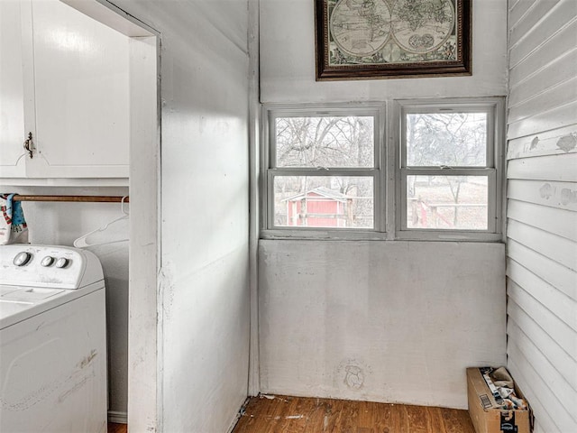 laundry room featuring hardwood / wood-style flooring, cabinets, washer / dryer, and a wealth of natural light