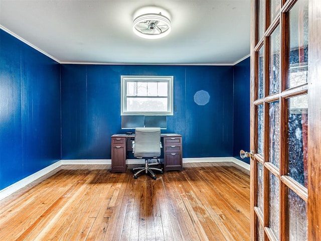 unfurnished office with hardwood / wood-style floors and crown molding