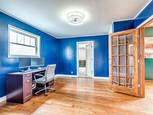 home office featuring light hardwood / wood-style flooring and ornamental molding